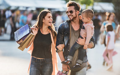 Young happy parents having fun with their son in shopping. young parents with baby