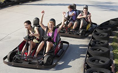 Teenagers riding go-carts Teenagers riding go-carts