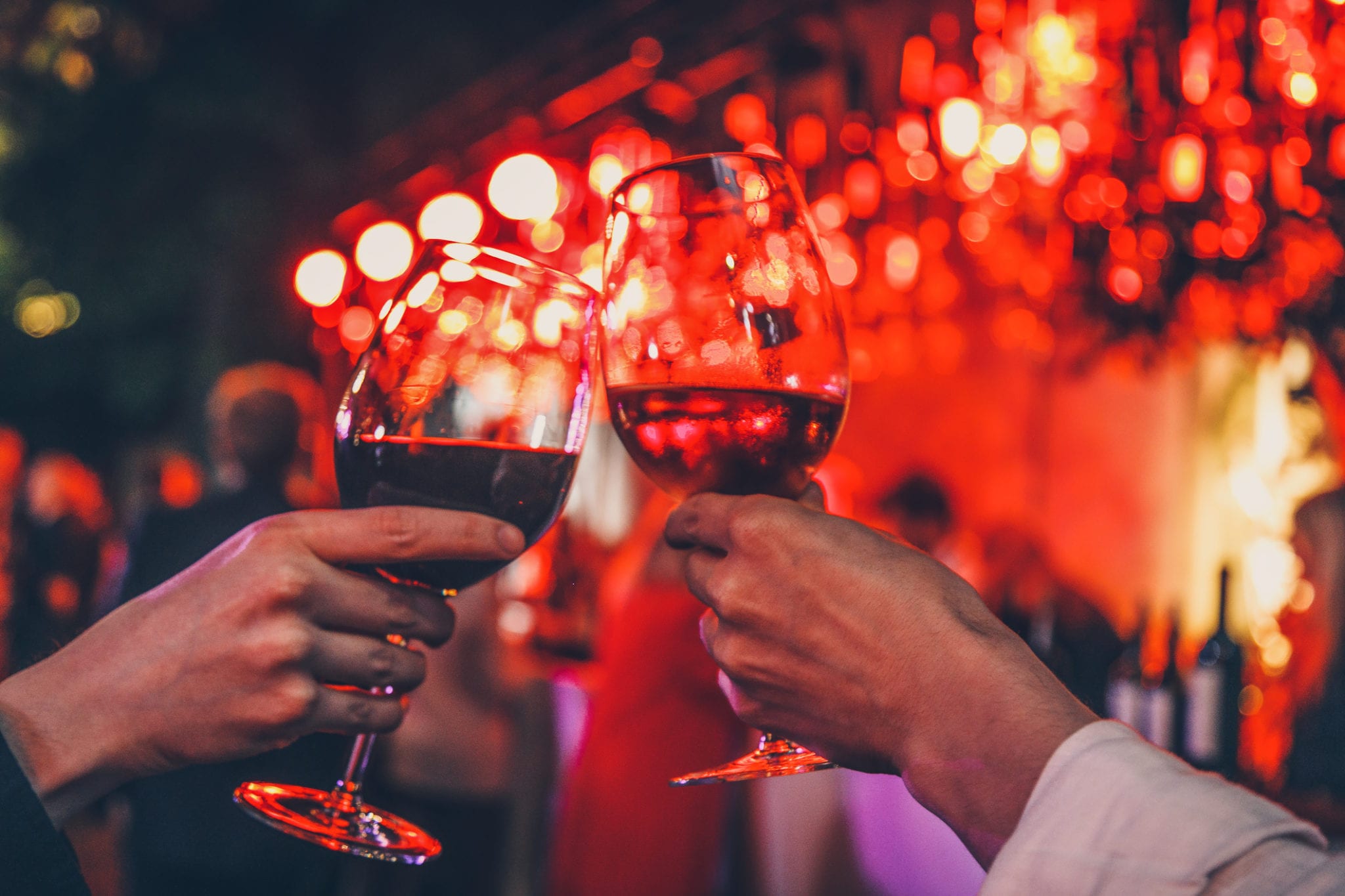 Couple toasting wine glasses over Valentine's Day dinner