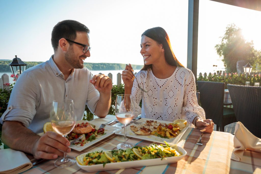 Romantic couple enjoying dinner al fresco along the Murrells Inlet Marsh Walk