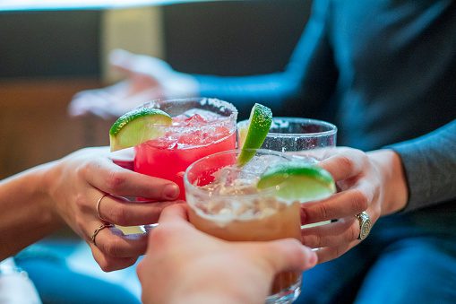 Group of friends toasting with margaritas