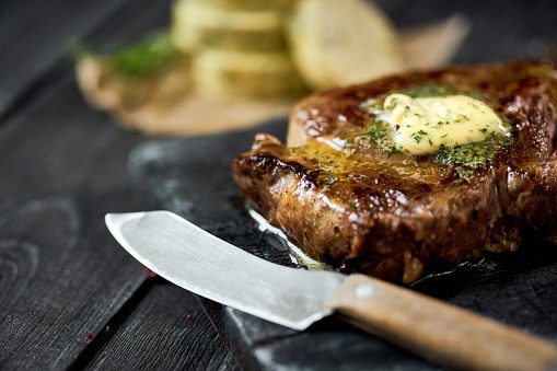 Beef steak with garlic butter and steak knife