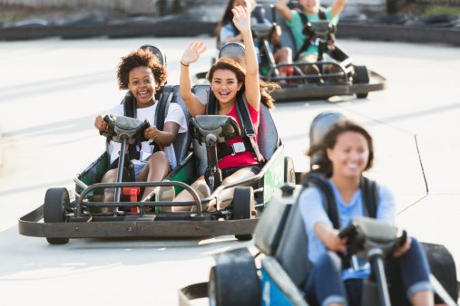 Teenage girls on go cart at Broadway Grand Prix