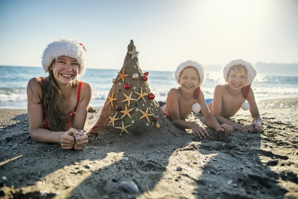 kids enjoying christmas at the beach in myrtle beach in december