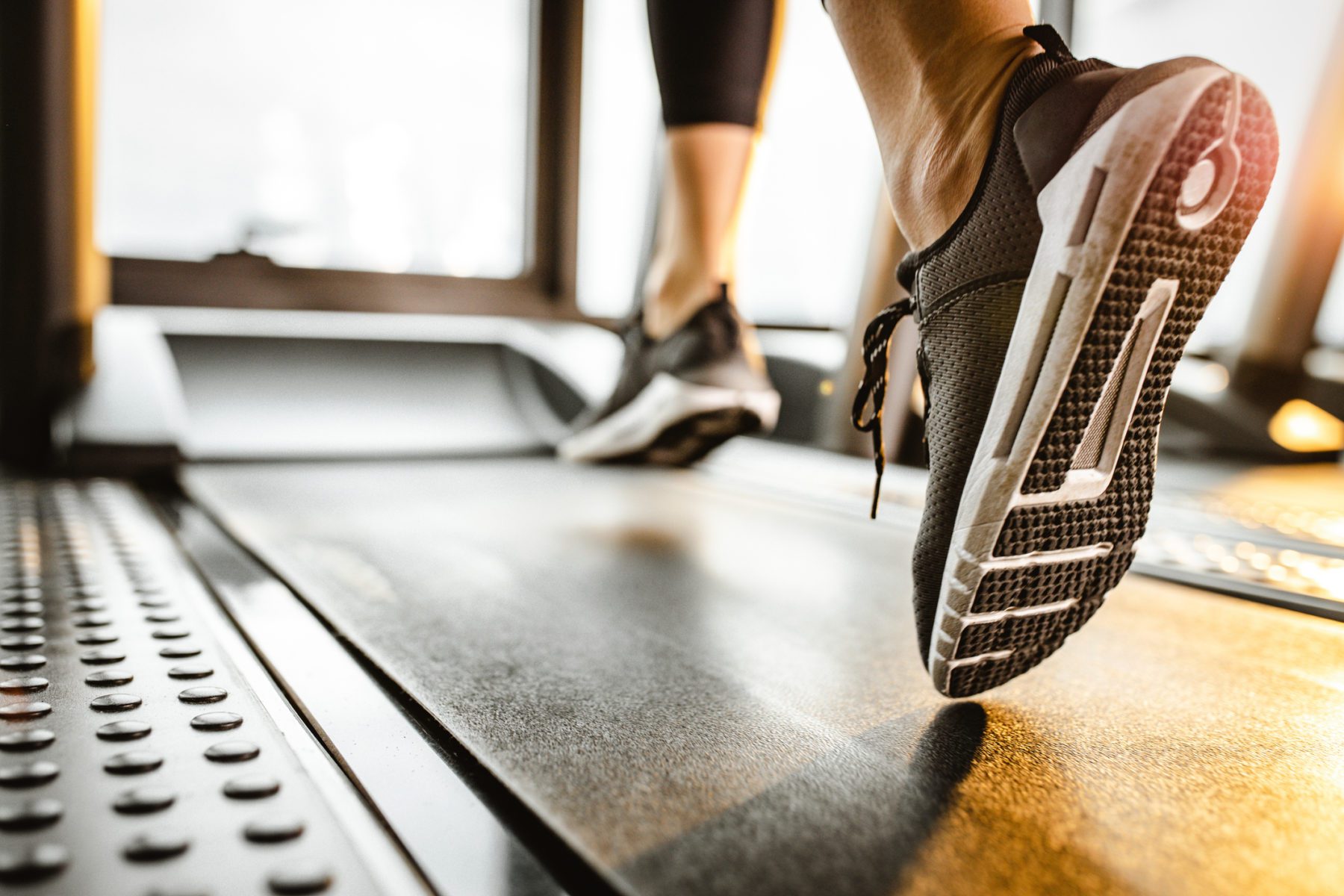 close up of unrecognizable athlete running on a treadmill in myrtle beach exercise room.