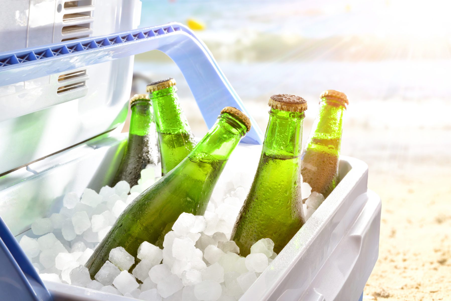 Beer chilled on ice in cooler on the beach