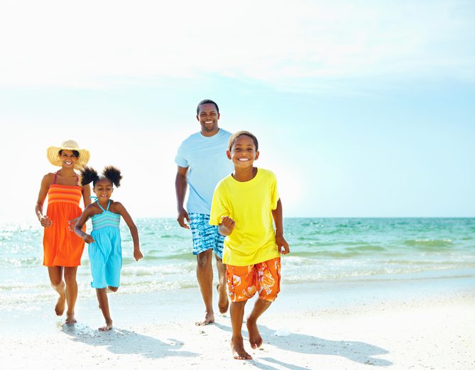African American family running toward the camera in Myrtle Beach