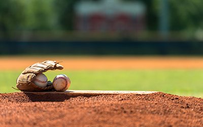 Baseball mitt and baseballs on pitchers mound