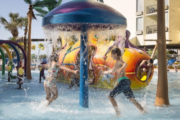 Children playing under a water fountain